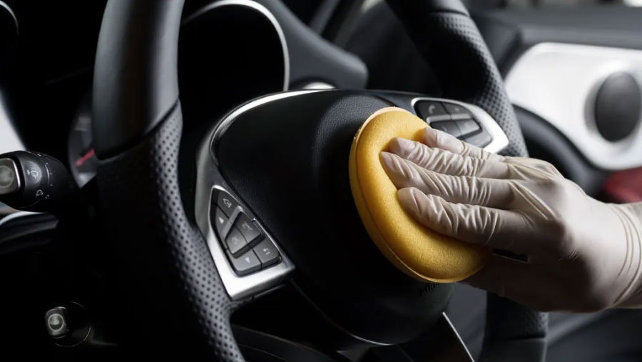 Interior detailing of a steering wheel before sale